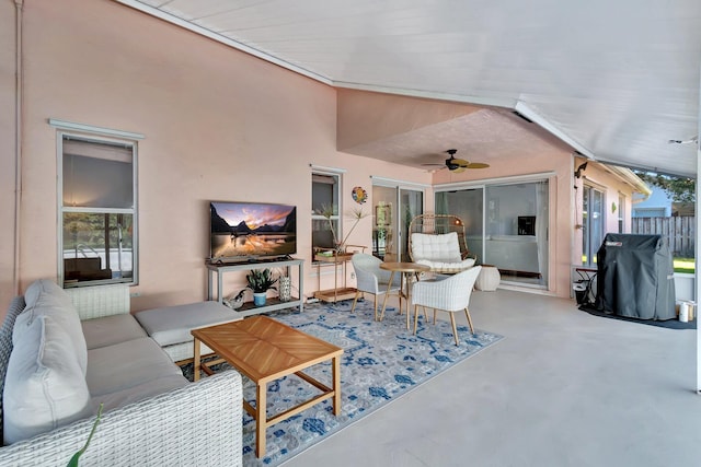 living room with concrete floors and ceiling fan