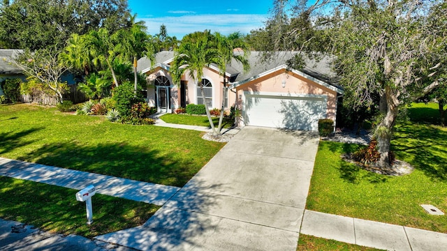 view of front of home with a front yard and a garage