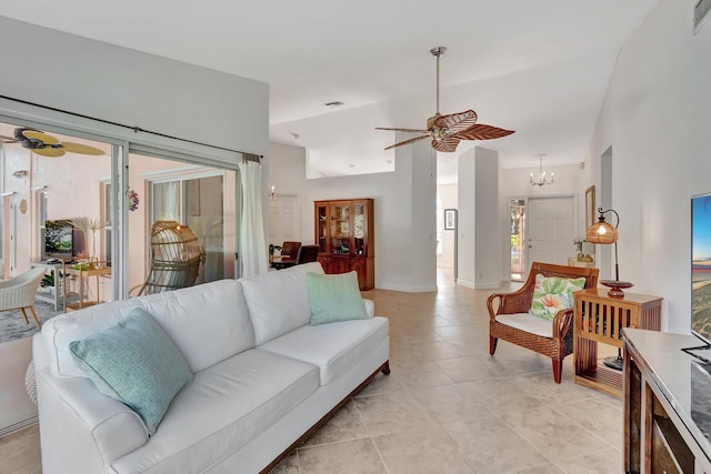 living room with ceiling fan with notable chandelier