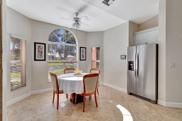 dining room with ceiling fan and a textured ceiling