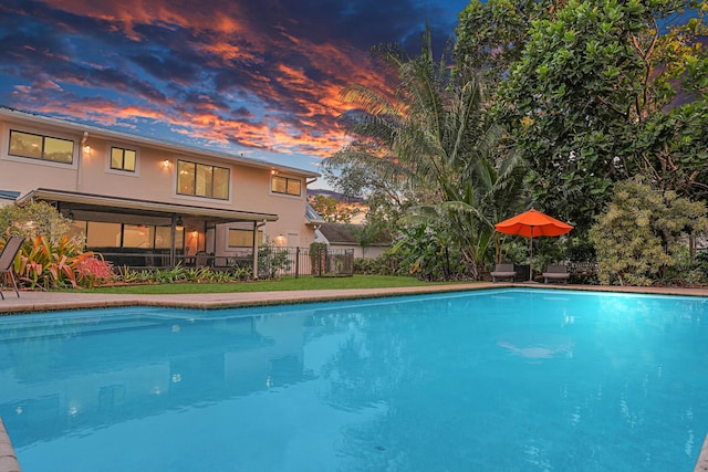 view of pool at dusk