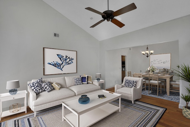 living room featuring wood-type flooring, ceiling fan with notable chandelier, and high vaulted ceiling