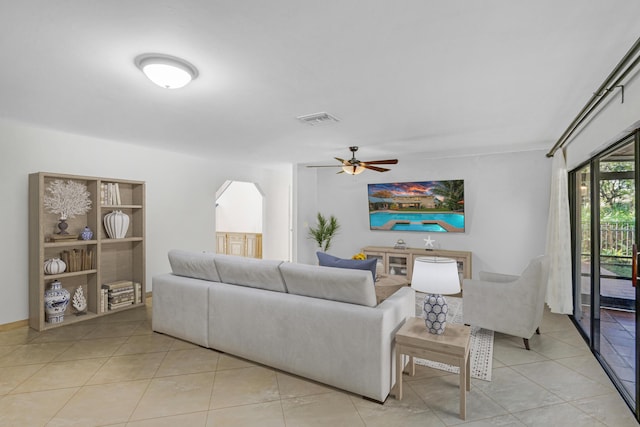 tiled living room with ceiling fan