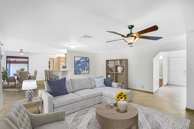 living room featuring light tile patterned floors and ceiling fan