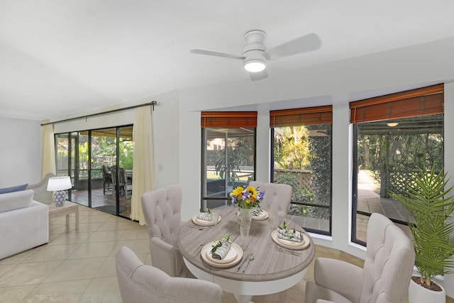 tiled dining area with ceiling fan and a wealth of natural light