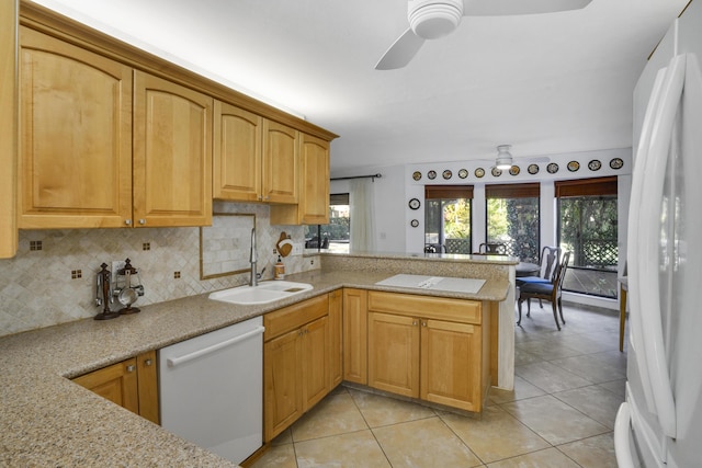 kitchen with white appliances, tasteful backsplash, light tile patterned floors, sink, and kitchen peninsula