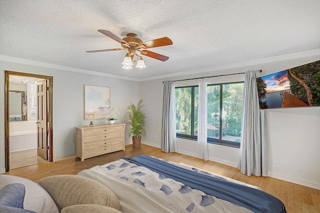 bedroom featuring ceiling fan, light hardwood / wood-style floors, a textured ceiling, and ensuite bathroom