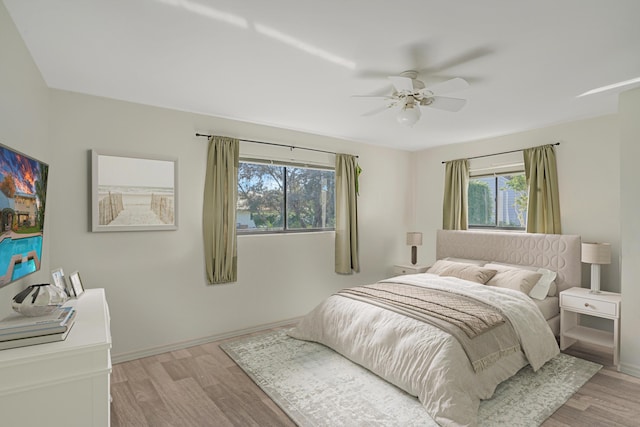 bedroom with light wood-type flooring and ceiling fan