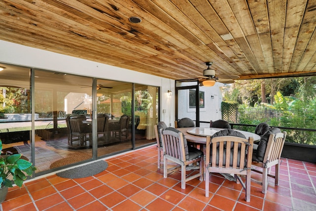 sunroom with ceiling fan and wooden ceiling