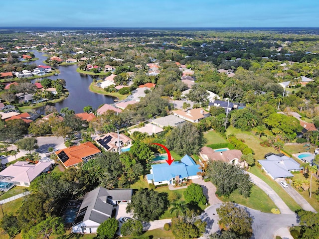 birds eye view of property with a water view