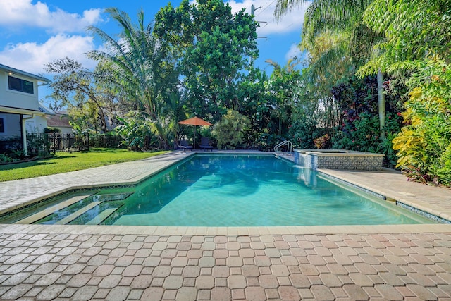 view of pool with an in ground hot tub and a yard