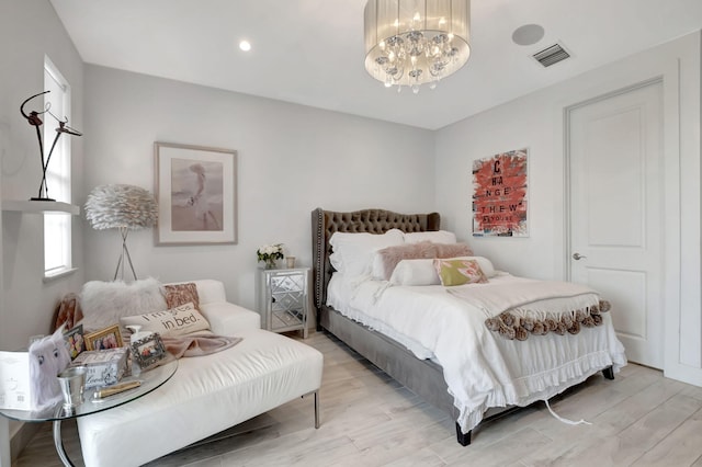 bedroom featuring a chandelier and light hardwood / wood-style floors