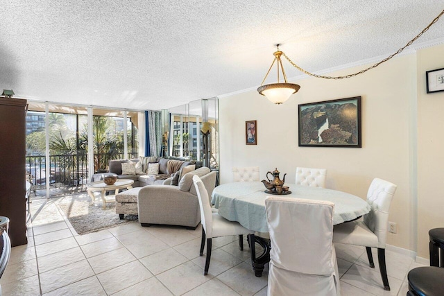 dining space with light tile patterned floors, a textured ceiling, and a wall of windows