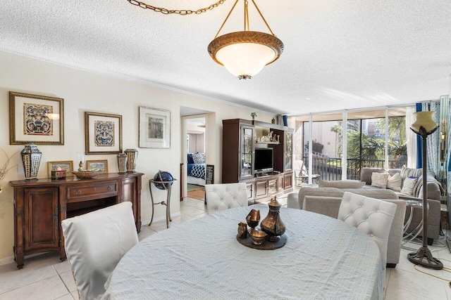 dining room featuring a wall of windows, a textured ceiling, and light tile patterned floors