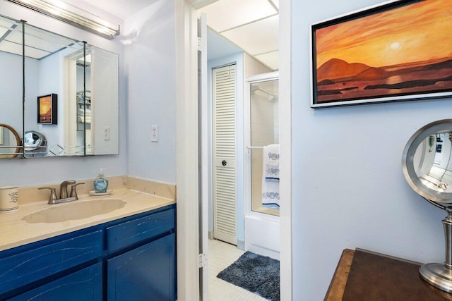 bathroom with vanity and combined bath / shower with glass door