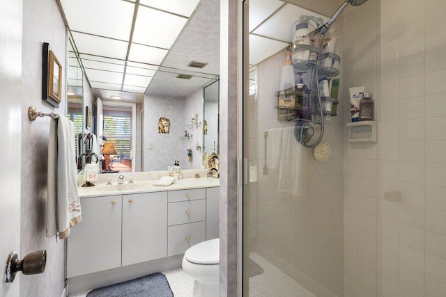 bathroom with vanity, an enclosed shower, and toilet