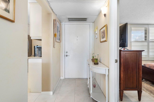 corridor with light tile patterned floors