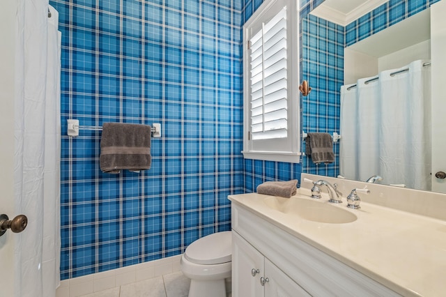 bathroom with tile patterned flooring, vanity, a healthy amount of sunlight, and toilet