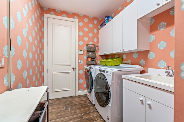 laundry room featuring washer and clothes dryer, cabinets, and sink