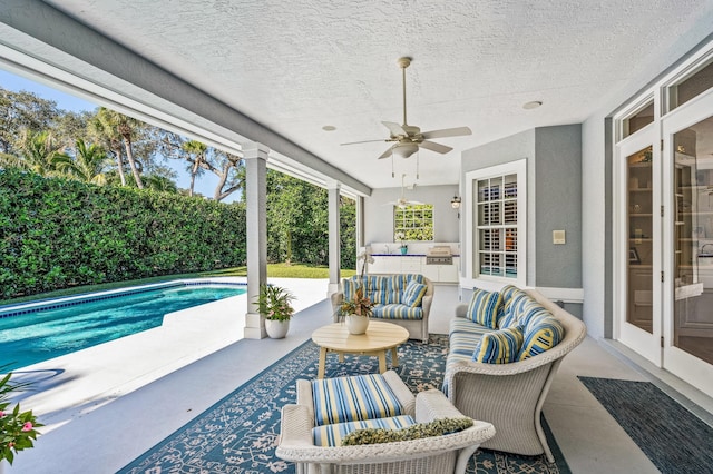 view of patio / terrace with a fenced in pool, outdoor lounge area, and ceiling fan