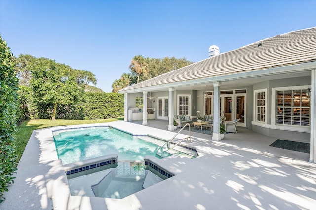 view of pool featuring an in ground hot tub, french doors, ceiling fan, and a patio