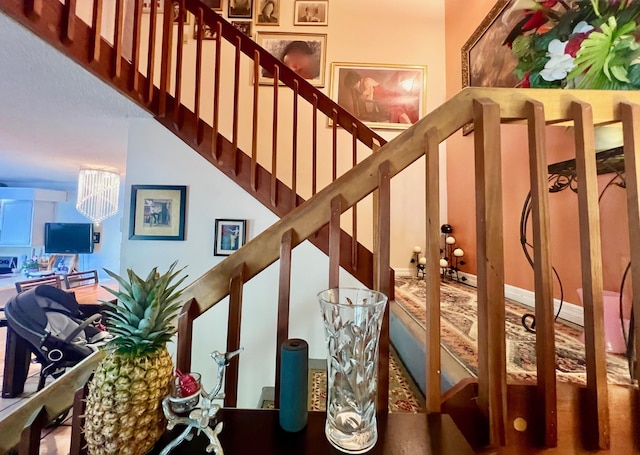 stairs with a chandelier