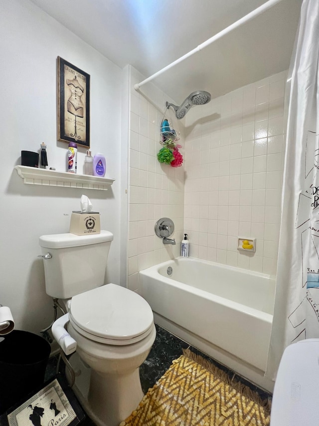 bathroom featuring shower / bath combination with curtain and toilet