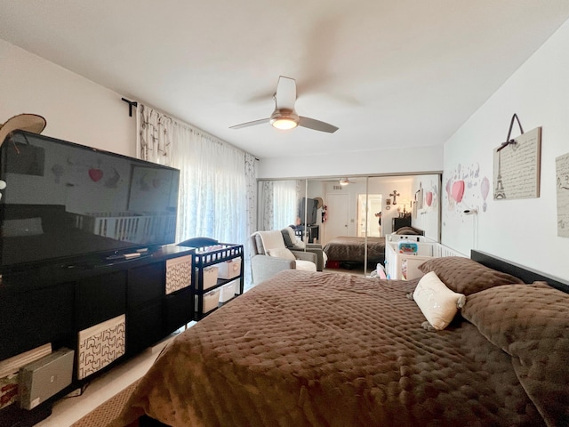 bedroom with ceiling fan, carpet floors, and a closet