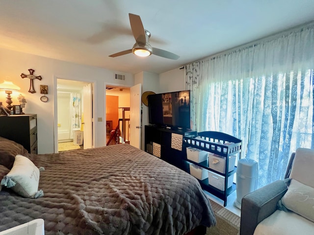 bedroom featuring ceiling fan and connected bathroom