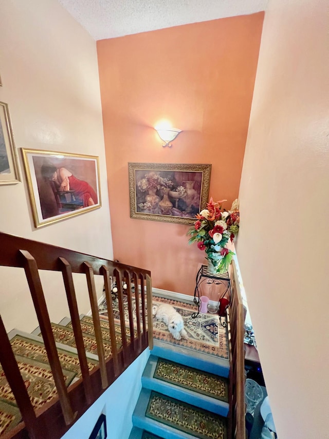 stairs with a textured ceiling