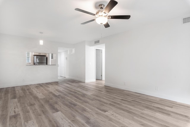 unfurnished living room featuring ceiling fan and light hardwood / wood-style flooring