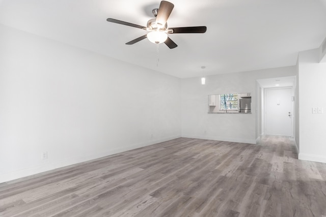 spare room featuring light hardwood / wood-style floors and ceiling fan