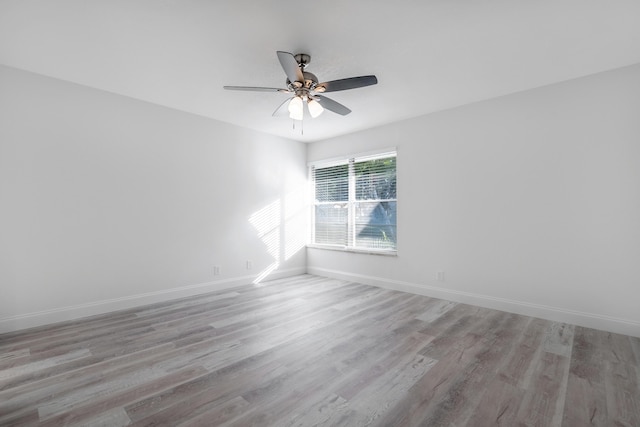 spare room featuring ceiling fan and light hardwood / wood-style flooring