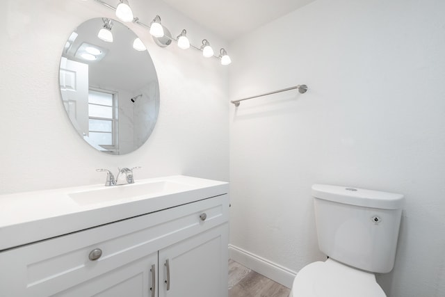 bathroom with hardwood / wood-style flooring, vanity, and toilet