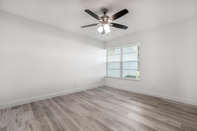 spare room with light wood-type flooring and ceiling fan