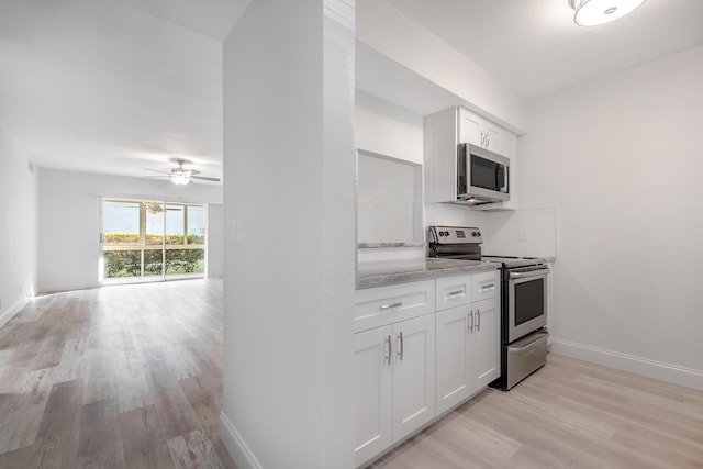 kitchen featuring white cabinetry, light hardwood / wood-style flooring, ceiling fan, and appliances with stainless steel finishes