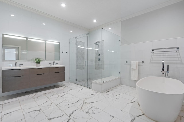 bathroom with vanity, separate shower and tub, crown molding, and tile walls