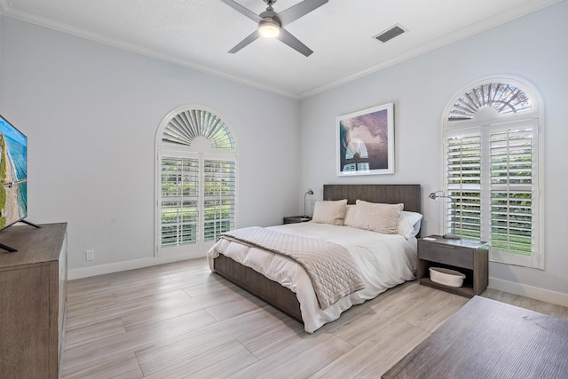 bedroom featuring ceiling fan, crown molding, and light hardwood / wood-style floors