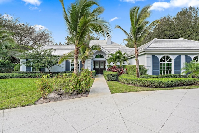 view of front of home featuring french doors and a front lawn