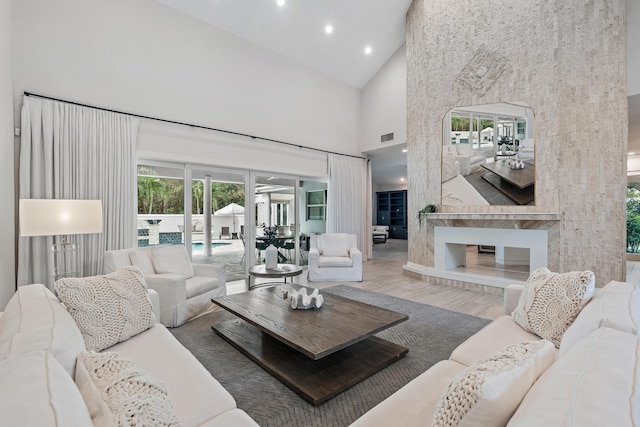 living room featuring hardwood / wood-style flooring and high vaulted ceiling