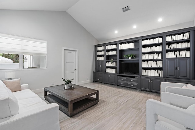 living room with high vaulted ceiling