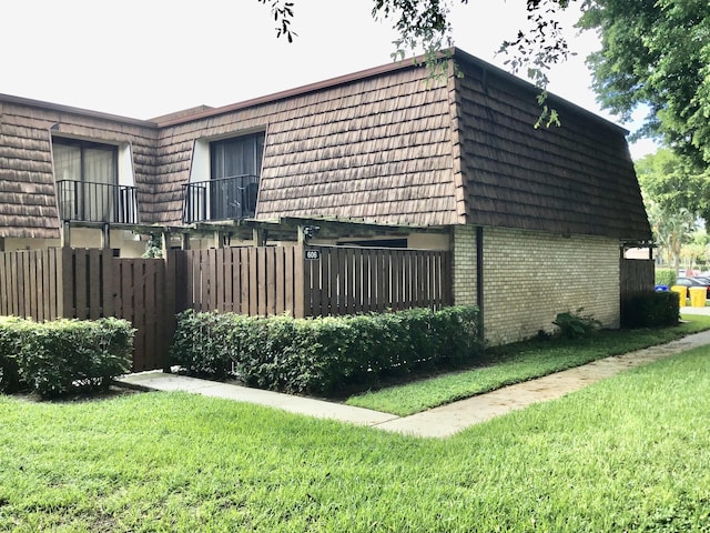 view of property exterior with a lawn