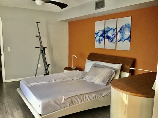 bedroom with ceiling fan and dark hardwood / wood-style flooring