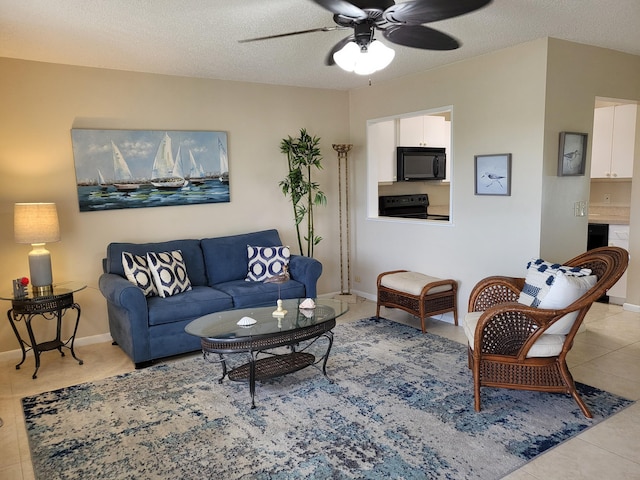 living room with a textured ceiling, ceiling fan, and light tile patterned flooring