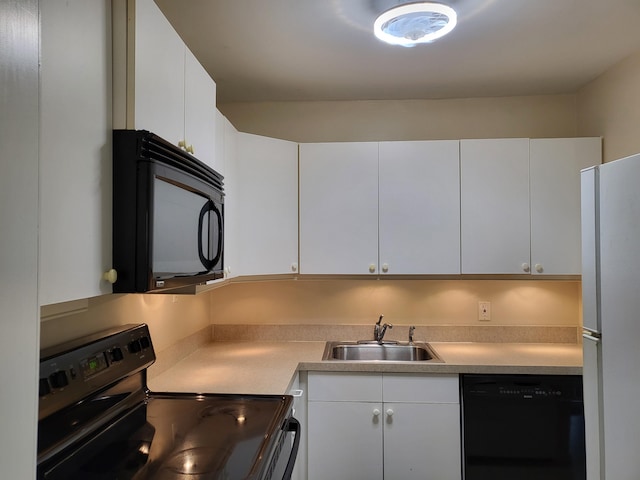 kitchen with white cabinets, sink, and black appliances