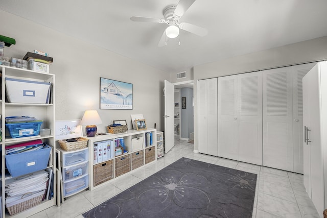 recreation room featuring tile patterned flooring and ceiling fan