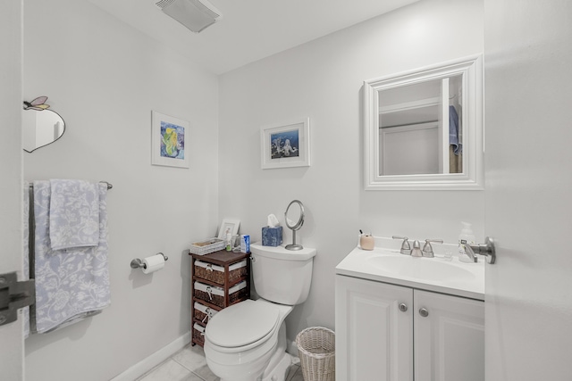 bathroom with tile patterned flooring, vanity, and toilet