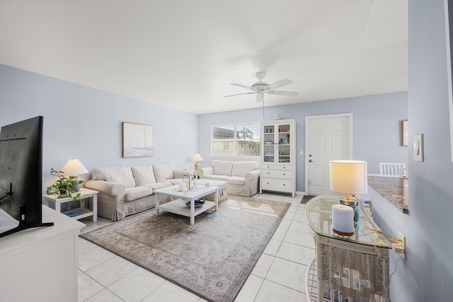 living room with ceiling fan and light tile patterned floors