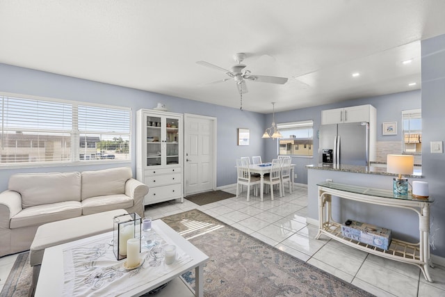 living room featuring ceiling fan and light tile patterned floors