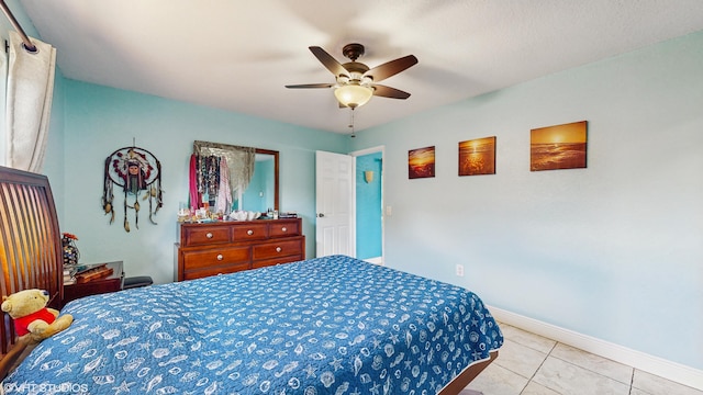 tiled bedroom featuring ceiling fan